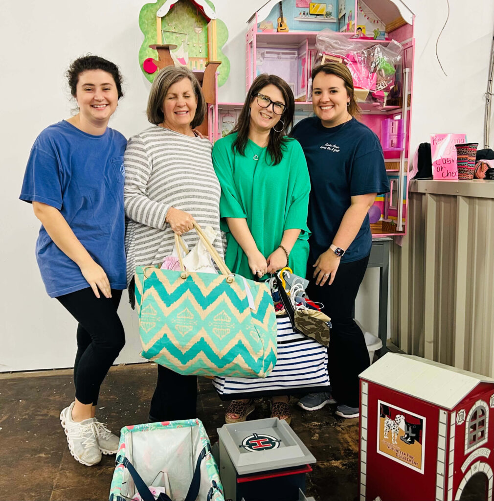 Four women shopping at Doodlebugs Kids Consignment Sale.